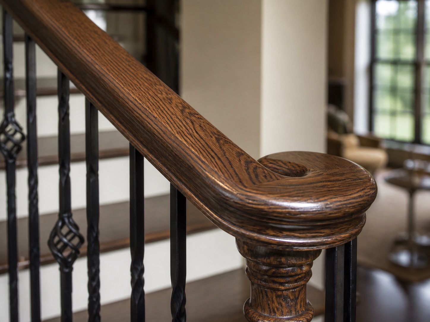 Close view of a stained wood handrail with a smooth satin finish